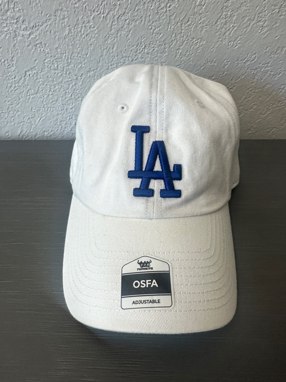 Genuine Merchandise White Baseball Cap with Navy and Red Logo Tag
